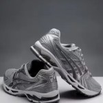 a pair of asics running shoes on top of a table