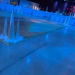 banquet setup with stage tables chairs and a dance floor themed christmas